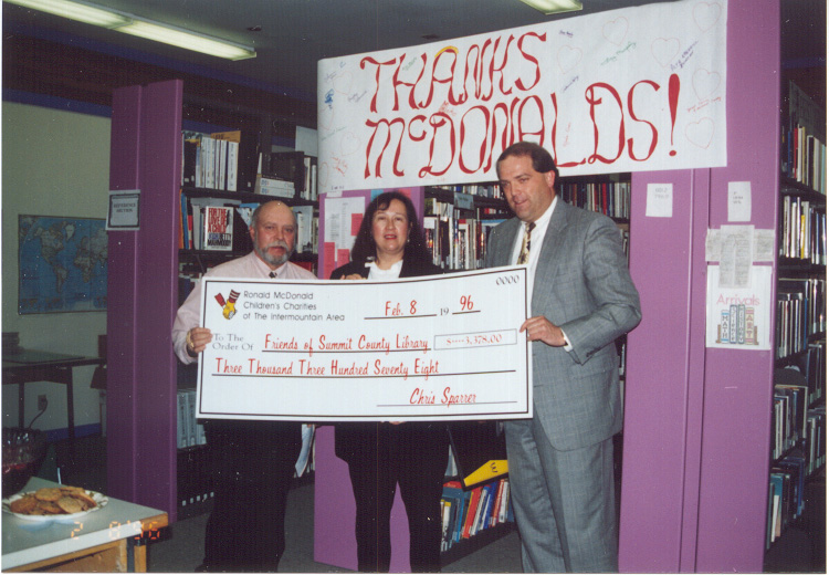 1996 Feb 8 Mark Young of McDonald’s Restaurant awards grant check for Summit County Library