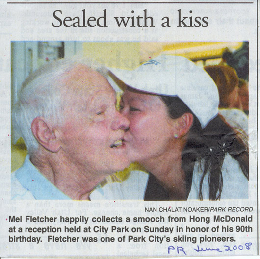 2008 June 18- Mel Fletcher happily collects smooch from Hong McDonald at his 90th birthday party.